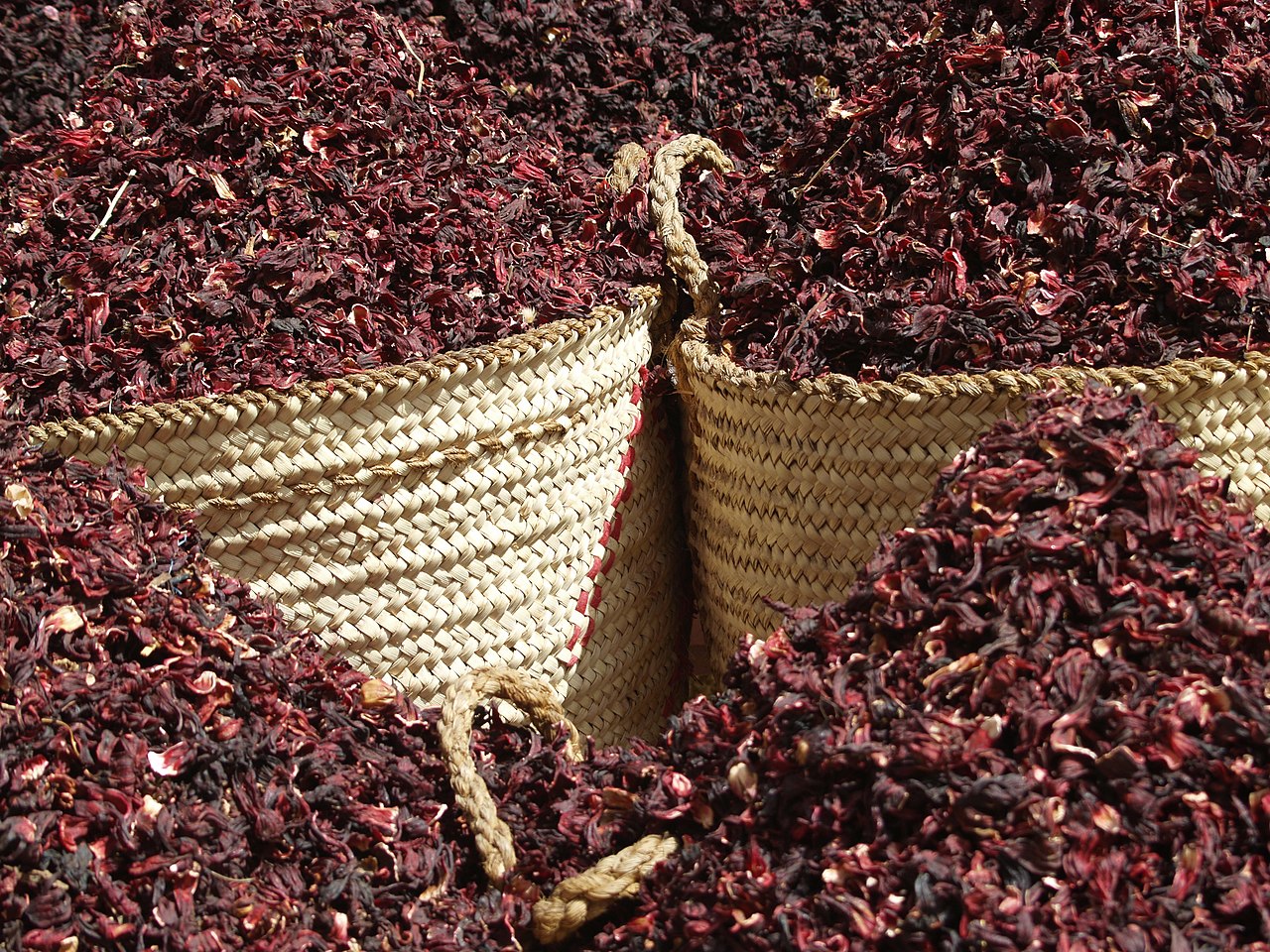 Dried hibiscus flowers in traditional basket